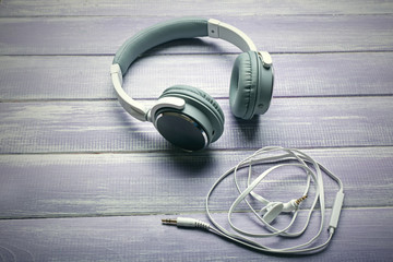 Headphones on wooden lilac background
