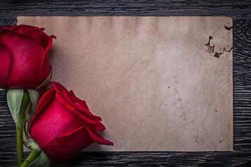 Vintage clean paper red natural roses on wooden board