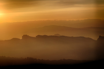 sunset on hilltops in the mist