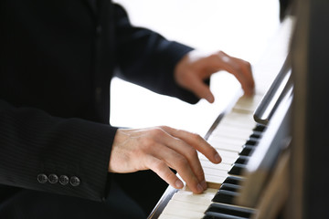Close up of man hands piano playing