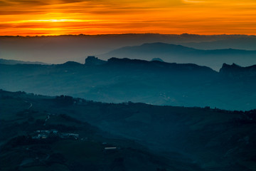 sunset on hilltops in the mist