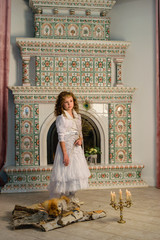 Girl in an ancient dress fireplace