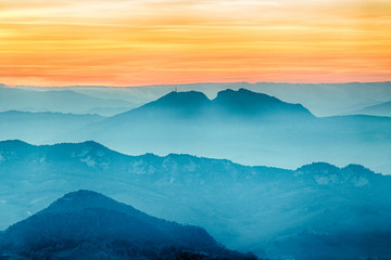 sunset on hilltops in the mist