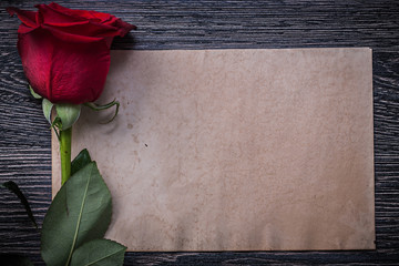 Vintage paper red scented rosebud on wood board