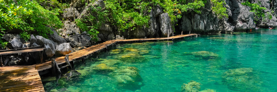 Very Clean and Clear lagoon lake Water next to a wooden path