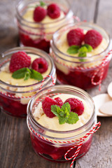 Colorful and delisious dessert in a jar berry cramble