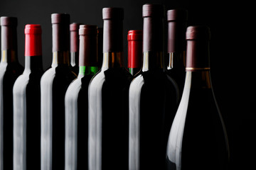 Wine bottles on black background