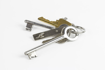 Bunch of metal keys of different shape on white background