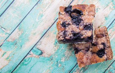 Portions of delicious homemade blueberry sponge cakes over wooden background