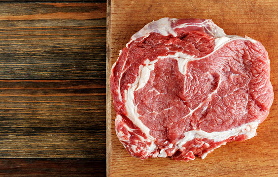 Raw ribeye steak on a cutting board