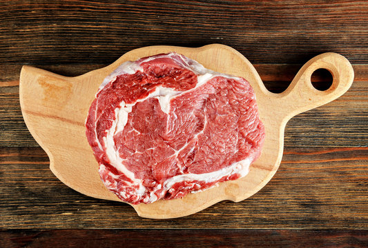 Raw ribeye steak on a cutting board