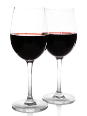 Two glasses of red wine on light background
