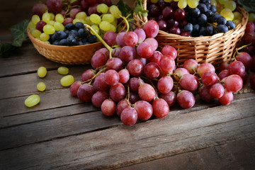 Grape in basket on wooden table