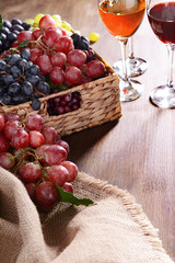 Grape in wicker box on table closeup