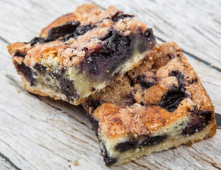 Portions of delicious homemade blueberry sponge cakes over wooden background