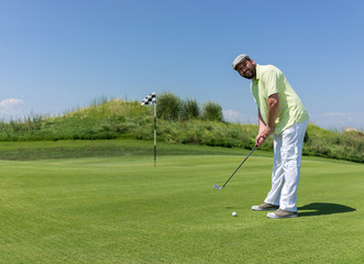 Fototapeta premium Man playing golf at club