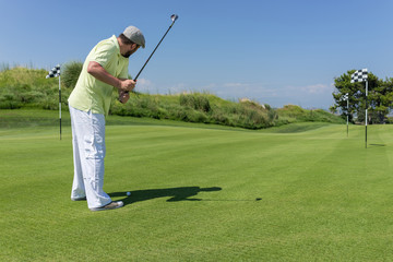 Man playing golf at club