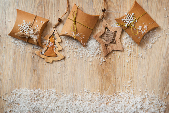 Christmas gifts in kraft paper with a homemade toys with snow