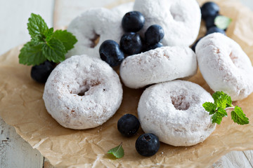 Powdered sugar donuts on parchment
