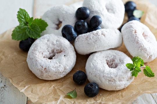 Powdered Sugar Donuts On Parchment