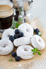 Powdered sugar donuts on parchment