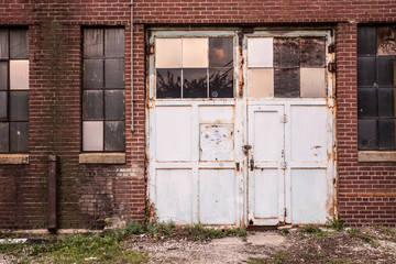 Grungy old garage door on abandoned factory