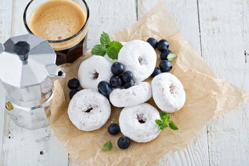 Powdered sugar donuts on parchment
