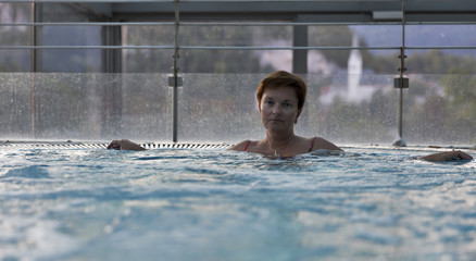 Middle aged Caucasian woman relaxing in jacuzzi