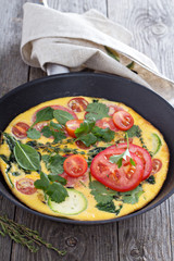Fresh fritatta with zucchini and tomatoes