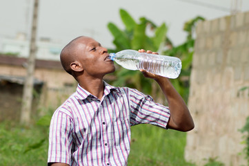 young man drinking mineral  water 