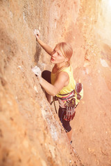 Female rock climber on the wall