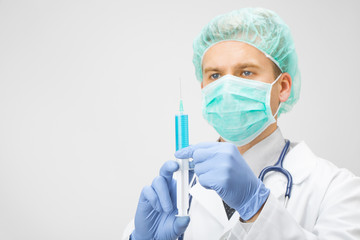 Doctor with syringe in hands preparing for injection