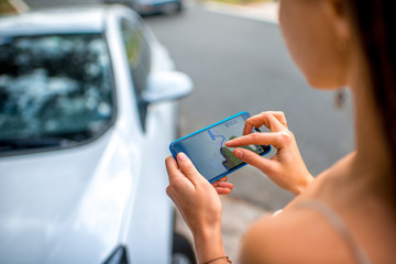 Woman using gps near the car