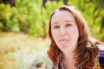 Fototapeta premium Girl sticking out her tongue
