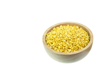 Macro peeled split mung bean in wooden bowl isolated on white