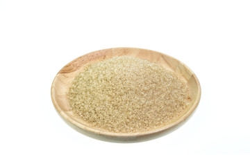 Close up of brown sugar in wooden bowl isolated on white