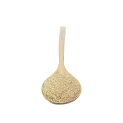 Close up of brown sugar in wooden spoon isolated on white