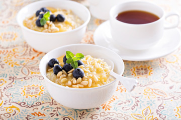 Cooked millet porridge with lemon curd and blueberry