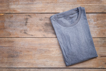 Top view of color T-Shirt on grey wood plank