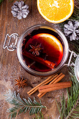 Christmas drink with orange fruit, anise, cinnamon and cloves on wooden table
