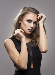 Fashionable beautiful young girl in 20s, posing. Studio shot, si