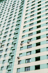 Multistoried building fa&ccedil;ade with air-conditioners on wall.
