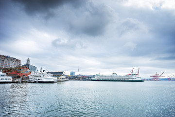 Fototapeta premium yachts and liner along dock on sea in cloudy sky