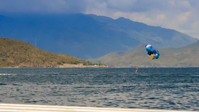view of parasailing over azure sea against mountains