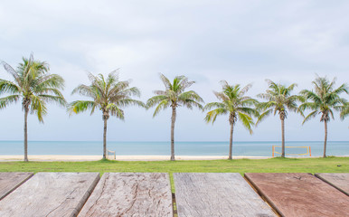 Fototapeta na wymiar Empty perspective wood over palm tree on the beach background