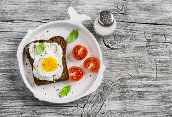 Healthy food - a sandwich with rye bread, soft cheese and boiled egg. On a light rustic wood surfaces. Healthy Breakfast or snack