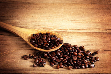 Coffee beans on wood background
