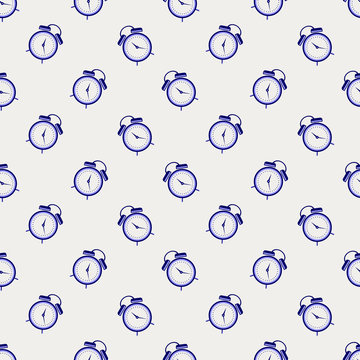 Seamless vector pattern. Symmetrical background with blue alarm clocks on the light background.
