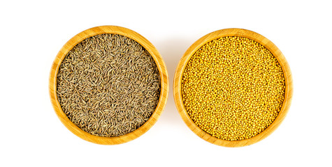 Overhead shot of cumin and yellow mustard seeds