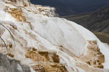 Cascading carbonate rock with valley below at Mammoth Hot Springs, Yellowstone National Park, Wyoming.